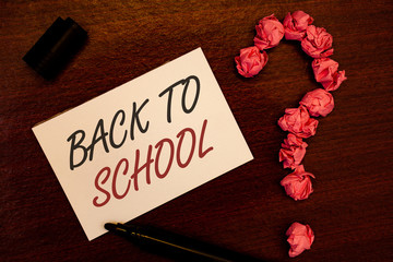 Text sign showing Back To School. Conceptual photo Return to class first day of studies Classroom Arriving Text white paper note black marker open cap pink crumbled paper question
