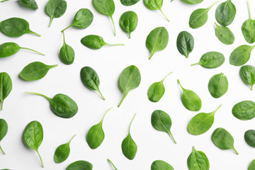 Fresh green leaves of healthy baby spinach on white background, top view