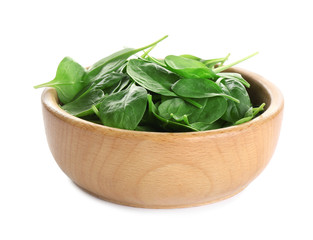 Wooden bowl of fresh green healthy baby spinach on white background