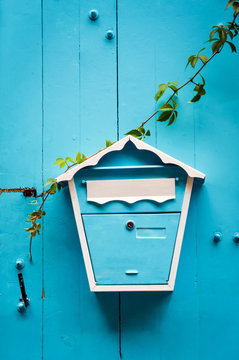 fashion design post box or mailbox for letters on a blue wooden door