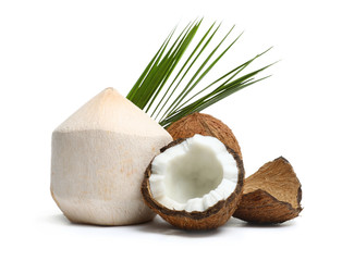 Fresh ripe coconuts with leaves on white background