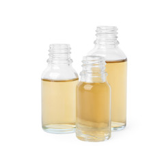 Glass bottles of essential oils on white background