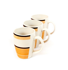 Row of three mugs isolated on white background