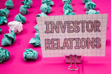 Conceptual hand writing showing Investor Relations. Business photo showcasing Finance Investment Relationship Negotiate Shareholder Paperclip with pink letters pink ground green paper lobs