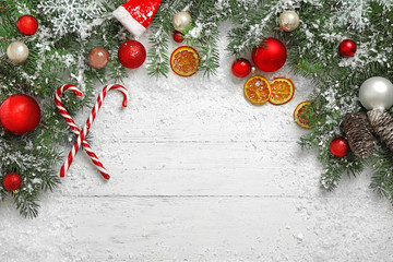 Christmas decoration with snow on white wooden background, flat lay. Space for text