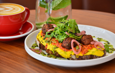 Falafel, scramble egg on a slice of sourdough bread