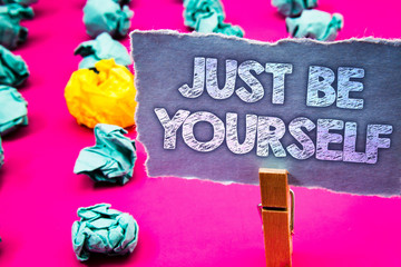 Writing note showing Just Be Yourself. Business photo showcasing Self Attitude Confidence True Confident Honesty Motivation Words torn paper wooden clip pink background crumbled yellow blue note