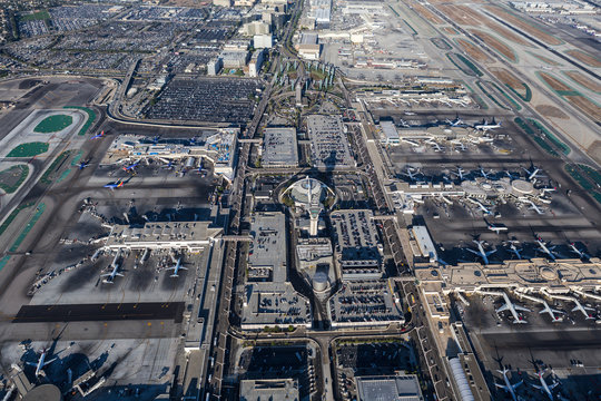 Afternoon aerial view of airplanes, terminals, runways, parking garages and roads at LAX airport on August 16, 2016 in Los Angeles, California, USA.