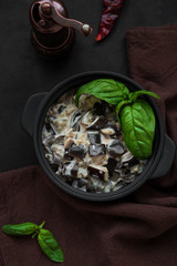 Eggplant curry on dark wooden background. Top view. Copy space. Healthy food concept