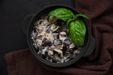 Eggplant curry on dark wooden background. Top view. Copy space. Healthy food concept