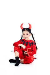 girl in a halloween fancy dress devil