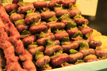 Skewers of Spanish sausages with green pepper in the Boqueria market