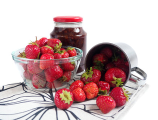 Strawberry jam in a jar on white background