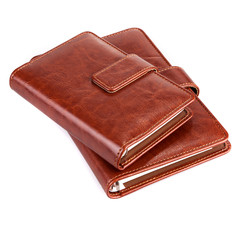 Stack of brown leather notebook on a white background
