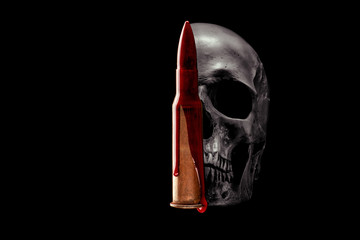 Human Skull and bloody bullet on black background. Crime, war concept. 