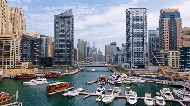 Scenic shot of floating boat near the beautiful buildings in Dubai, United Arab Emirates
