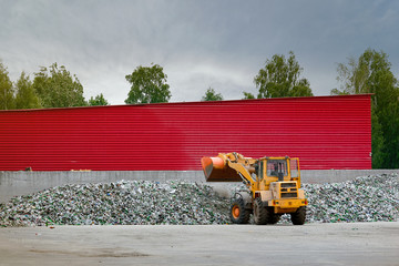 Front loader working at yard of sorting cullet. Recycle cullet at yard of processing plant....