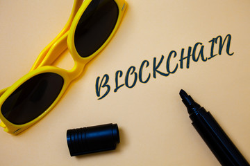 Writing note showing Blockchain. Business photo showcasing Register Log Financial Statement Digital Data Technology Record Ideas messages beige background black marker markers yellow sunglasses