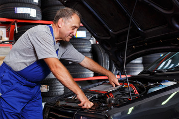 man mechanic engaged in car repair