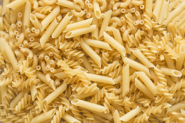 Background of pasta of various kinds top view. Many different sorts of pasta, italian cuisine concept.