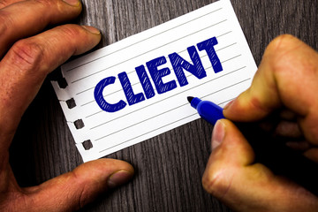 Writing note showing Client. Business photo showcasing Purchaser Customer Shopper User Patron Prospect Sharer Investor Buyer Man hold holding marker notebook paper ideas wood wooden background