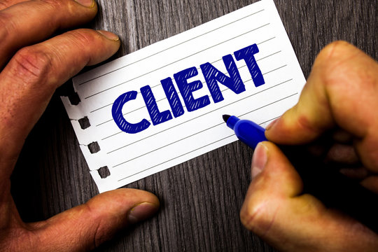 Writing note showing Client. Business photo showcasing Purchaser Customer Shopper User Patron Prospect Sharer Investor Buyer Man hold holding marker notebook paper ideas wood wooden background