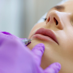 Beautiful woman on rejuvenation procedure in beauty clinic.