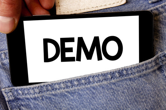 Handwriting text Demo. Concept meaning Trial Beta Version Free Test Sample Preview of something Prototype Man hold holding cell phone white screen message application technology
