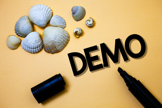 Conceptual hand writing showing Demo. Business photo text Trial Beta Version Free Test Sample Preview of something Prototype Yellow background shadow open marker shells beach memory memories