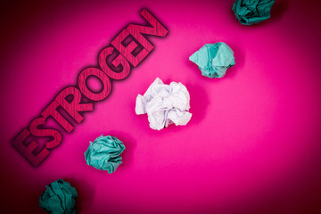 Conceptual hand writing showing Estrogen. Business photo text Group of hormones promote the development of female characteristics Ideas messages pink background crumpled papers several tries