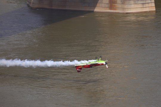 BUDAPEST, HUNGARY - MAY 1: Zoltan Veres fly under the Chainbridge as part of the May 1 celebration of 2014. Zoltan Veres is an European champion and Guiness record holder aerobatics pilot.