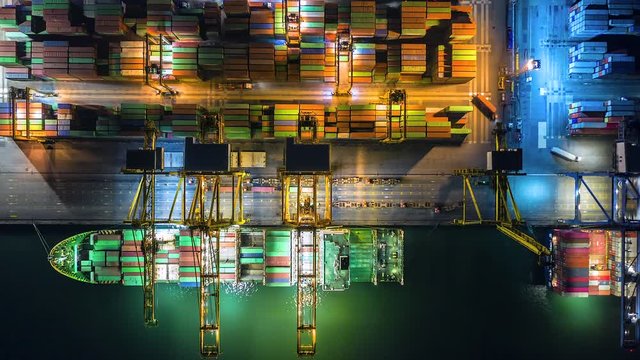 4K Time lapse Night of modern industrial port with containers from top view or aerial view. It is an import and export cargo port where is a part of shipping dock and export products worldwide