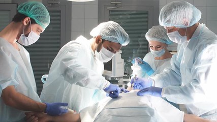 Medical Team Performing Surgical Operation in Bright Modern Operating Room.