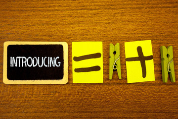 Word writing text Introducing. Business concept for Presenting a topic or someone Initial approach First meeting Ideas blackboard chalk equal plus signs clothespins wooden background