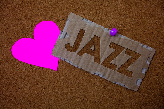 Conceptual hand writing showing Jazz. Business photo text Type of music of black American origin Musical genre Strong rhythm Brown old damaged paperboard ideas pink heart cork background