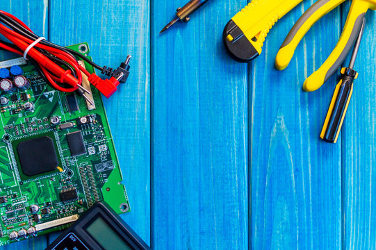Services for the production of electronics and repair on a wooden blue background.