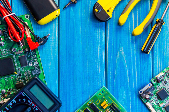 Services for the production of electronics and repair on a wooden blue background.