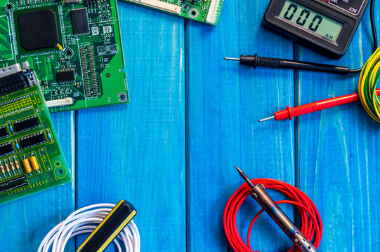 Services for the production of electronics and repair on a wooden blue background.