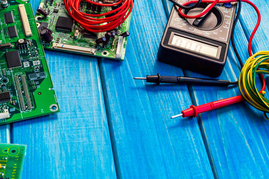 Services for the production of electronics and repair on a wooden blue background.