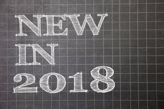 Writing note showing New In 2018. Business photo showcasing upcoming year resolution Advertising new product Specs Graph paper grey messages thoughts ideas information important math