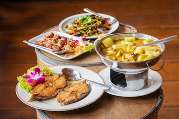 Southern delicious food of Thailand; Yellow curry with fish and bamboo shoot in hot pot, fried mackerel with fish sauce, sweet boiled squid and stir fried fish kidney. 
