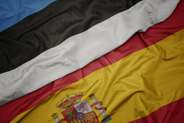 Fototapeta premium waving colorful flag of spain and national flag of estonia.