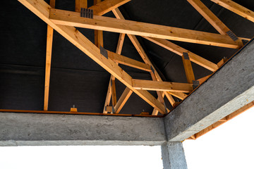 Roof trusses covered with a membrane on a detached house under construction, visible roof elements, battens, counter battens, rafters.