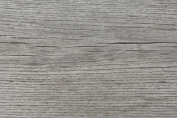 Background gray wooden old unpolished surface with horizontal fibers.
