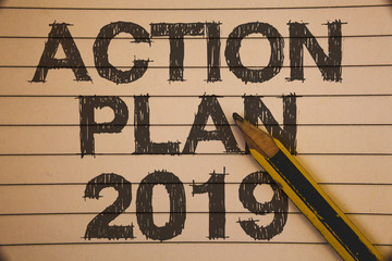 Writing note showing Action Plan 2019. Business photo showcasing Challenge Ideas Goals for New Year Motivation to Start Ideas concepts on old beige notebook paper pen resting black letters