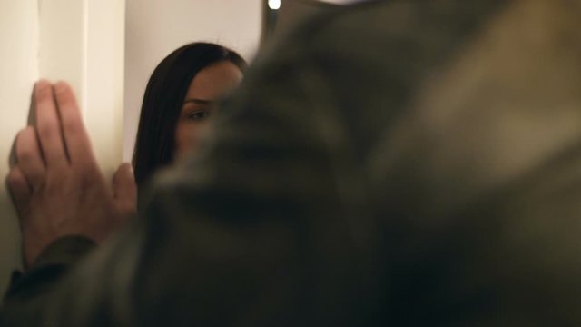 Crying woman is kneeling next to injured man on the floor