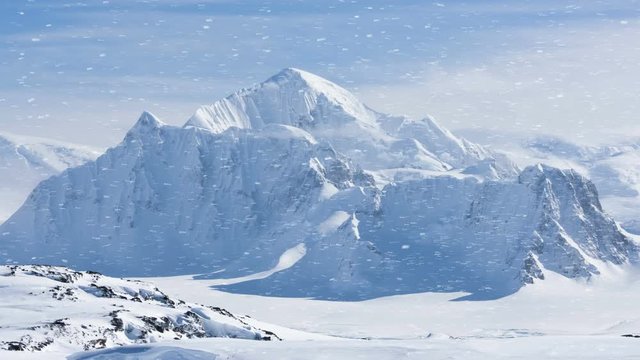 wonderful white frozen Antarctica hills under snow covering during heavy bizzard. Eploring beauty world. Travel, holidays, sports and recreation background. Slow motion 4K footage