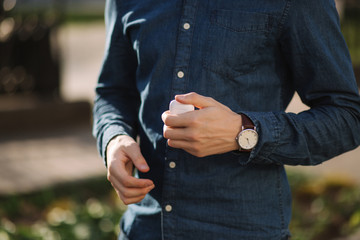 Close up of man hold case for wireless headphones in hands