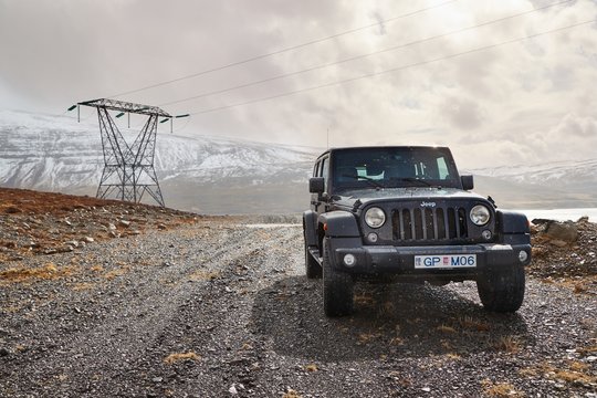 AKRANES, ICELAND - MAY 07, 2018: Jeep Wrangler Unlimited Four Wheel Drive Vehicle On A Path In The Hills For Electric Line Maintenance