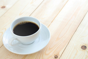 Black coffee cup on wood background